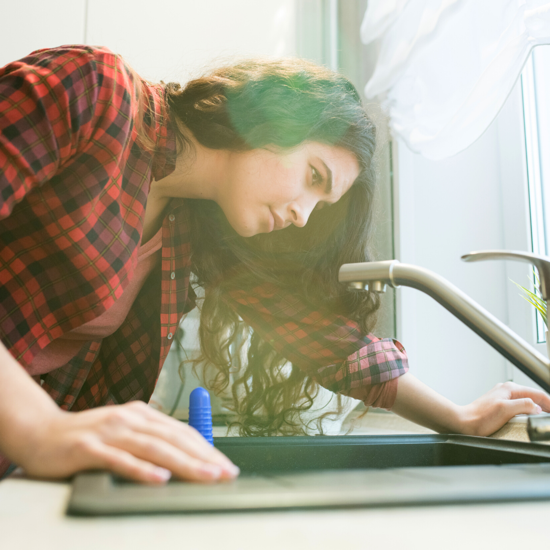 Woman inspecting sink