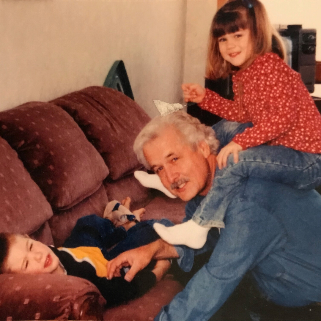 Dr. Versendaal smiling with two grandkids